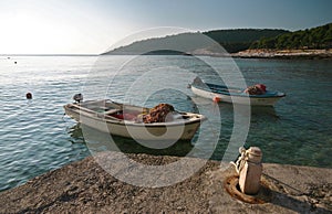 Fisherman on his boat followed by a crowd of seagulls, shot in Hvar, Croatia.