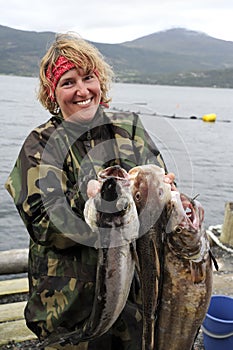 Fisherman on with his catch in hand. Norway