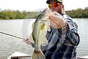 Fisherman holding Bass closeup