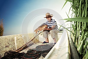Fisherman holding a big carp