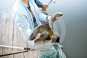Fisherman holding caught fish