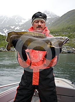 Fisherman holding fish