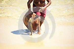 Fisherman holding a fish called Arraia and taking it to the colony