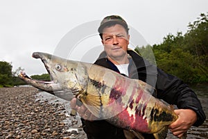 Fisherman holding a fresh caught fish