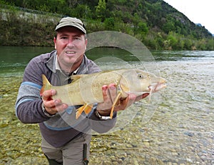 Fisherman holding a fresh caught fish