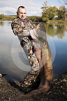 Fisherman holding a giant catfish.