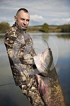 Fisherman holding a giant catfish.