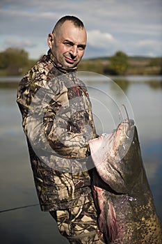 Fisherman holding a giant catfish.