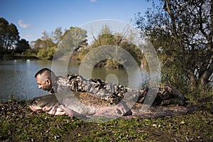 Fisherman holding a giant catfish.