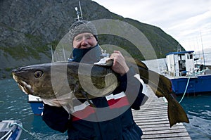 Fisherman holding huge fish photo