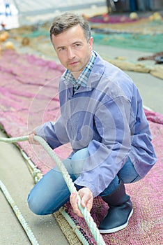 Fisherman holding rope net