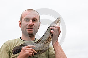 Fisherman holding a snakehead