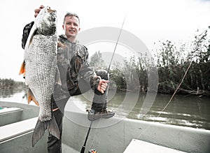 Fisherman holds the Asp fish