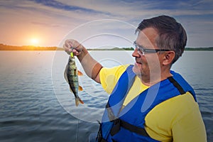 A fisherman holds a catch