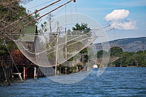 Fisherman house and net on the river in Montenegro