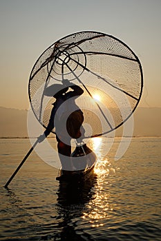 Fisherman of Inle Lake in action when fishing