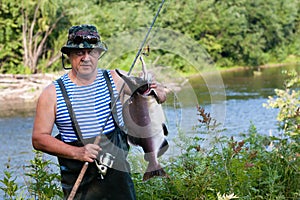 Fisherman keeps caught male pink salmon was caught in the river