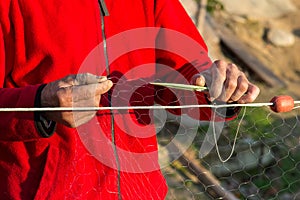 Fisherman knits fishing nets