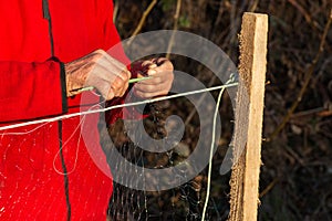 Fisherman knits fishing nets