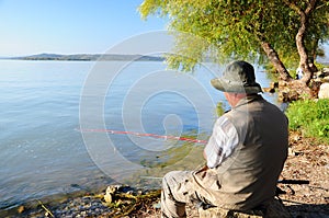 Fisherman by lake