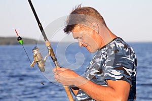 Fisherman on the lake closeup