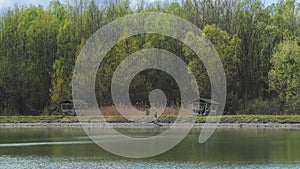 Fisherman, lake, forest. Fisherman in his hand holding spinning. Fishing, spinning reel, fish, Breg rivers, fishing