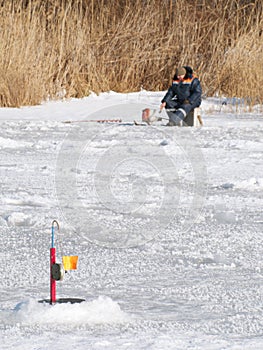Fisherman on the lake ice fishing rod