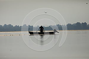 Fisherman on the lake puting the straps