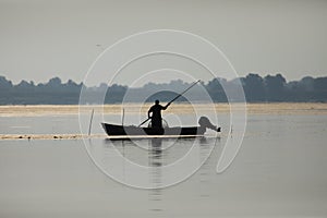 Fisherman on the lake puting the straps