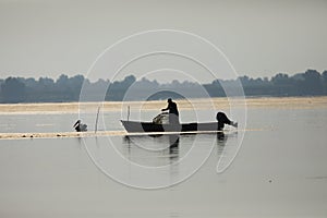 Fisherman on the lake puting the straps