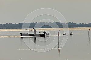 Fisherman on the lake puting the straps