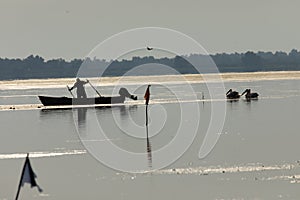 Fisherman on the lake puting the straps