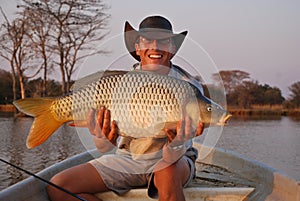 Fisherman with large carp