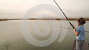 fisherman. little girl on a river fishing rod. vacations in nature.