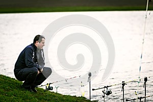 Fisherman looking at his rods waiting for a fish