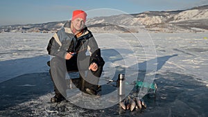 Fisherman is a man in winter fishing.