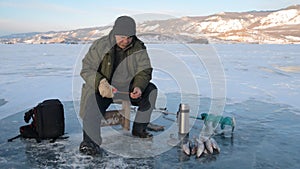 Fisherman is a man in winter fishing.
