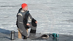 Fisherman is a man in winter fishing.