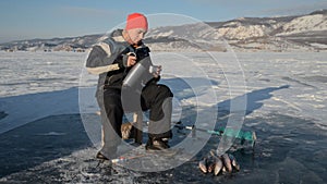 Fisherman is a man in winter fishing.