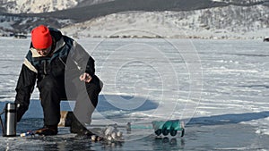 Fisherman is a man in winter fishing.