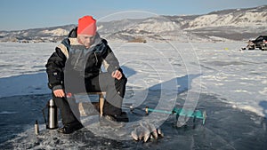 Fisherman is a man in winter fishing.