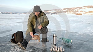 Fisherman is a man in winter fishing.