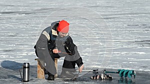 Fisherman is a man in winter fishing.