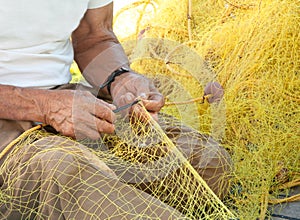 Fisherman Mending His Fishing Net in Greece