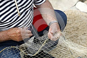 Fisherman Mending Nets photo