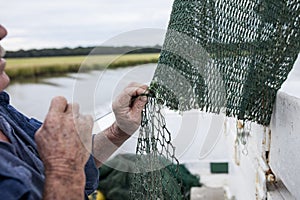 Fisherman mending nets photo