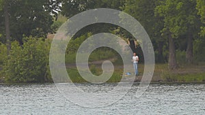 Fisherman on the opposite shore of the lake