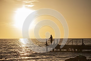 Fisherman on the pier at sunset in Bayahibe 6
