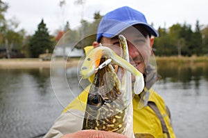 Fisherman Poses with Northern Pike Fish