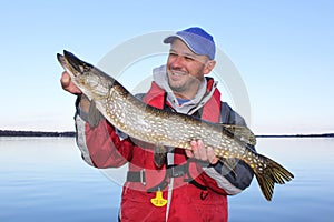 Fisherman Poses with Northern Pike Fish